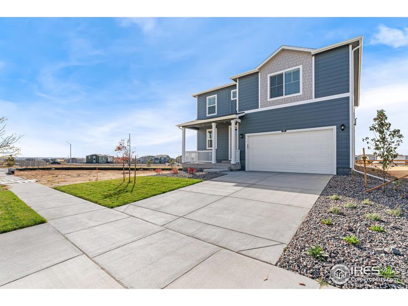 Front exterior of a new home in Settlers Crossing, Commerce City, CO, highlighting curb appeal (Image 17).
