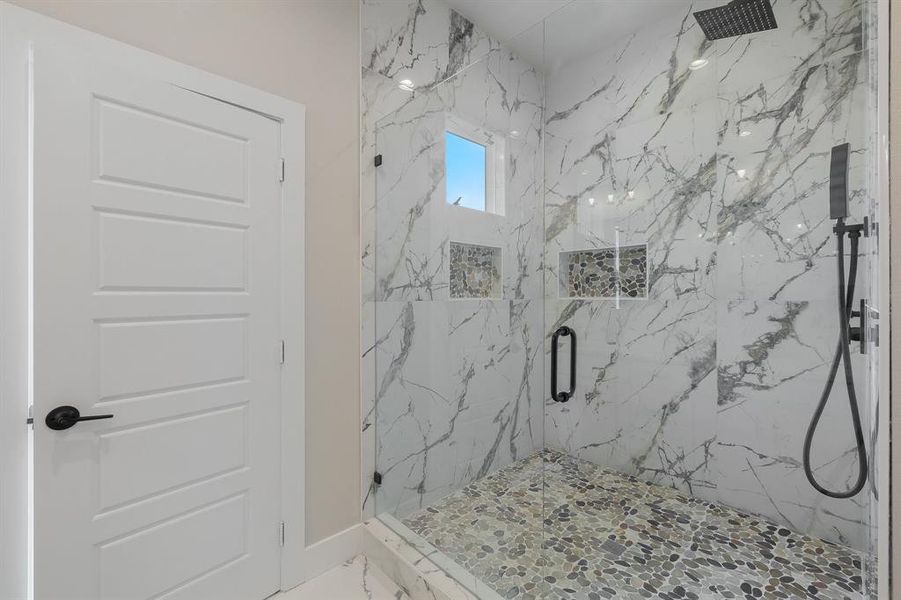 Bathroom with a marble finish shower, baseboards, and marble finish floors