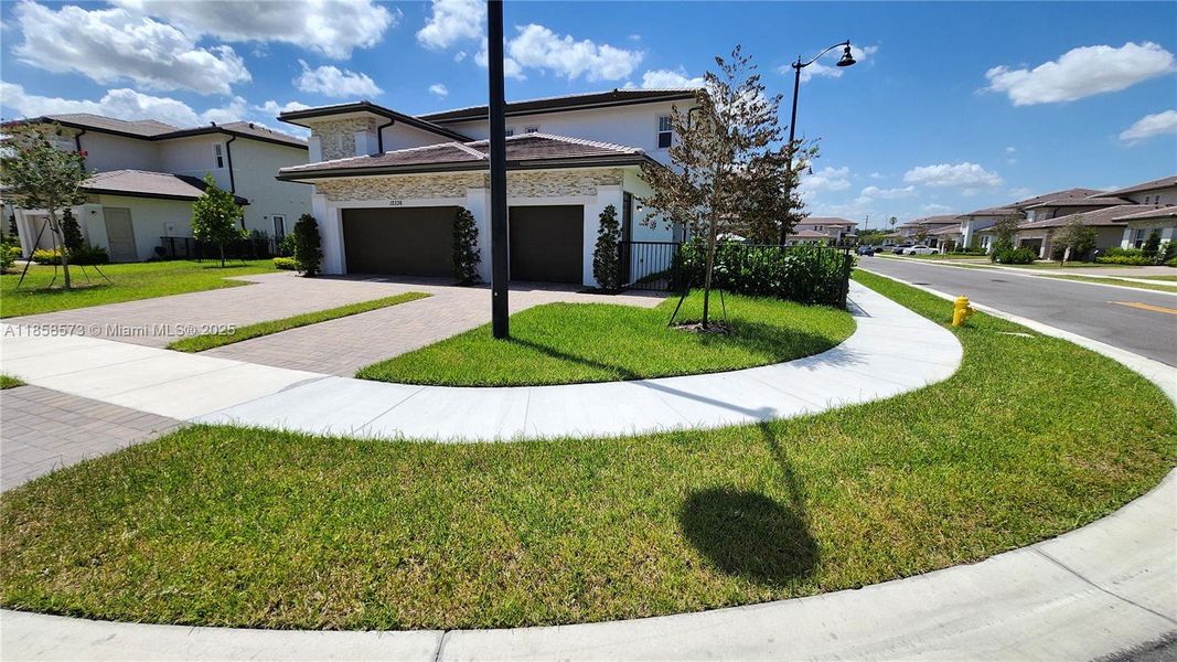 Front exterior of a new home in , Davie, FL, highlighting curb appeal (Image 1).