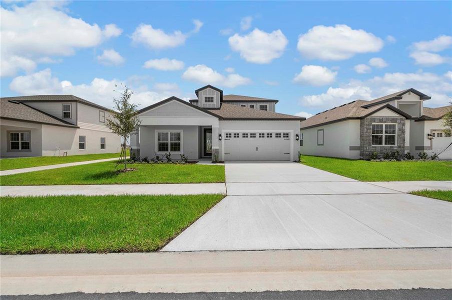 Front exterior of a new home in Gum Lake Preserve, Lake Alfred, FL, highlighting curb appeal (Image 19).