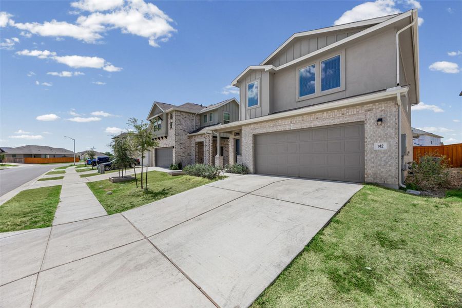 Front exterior of a new home in Crosswinds, Kyle, TX, highlighting curb appeal (Image 2). Front exterior of a new home in Crosswinds, Kyle, TX, highlighting curb appeal (Image 2).