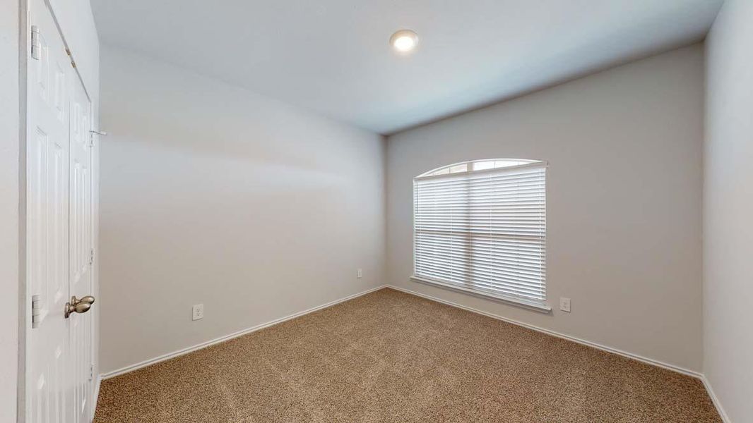 Carpeted empty room with baseboards