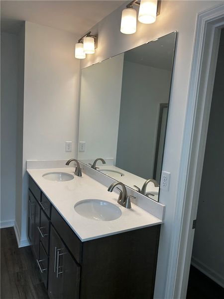 This modern bathroom features a double vanity with