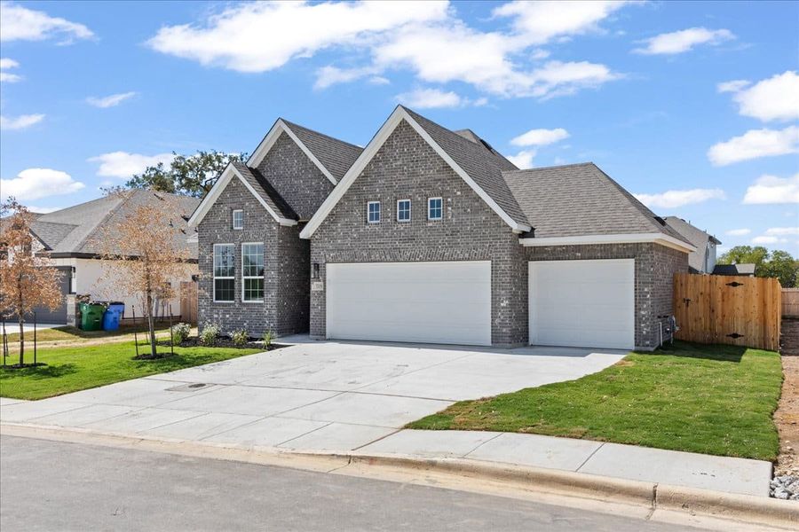 Front exterior of a new home in Village at Three Oaks, Seguin, TX, highlighting curb appeal (Image 16). Front exterior of a new home in Village at Three Oaks, Seguin, TX, highlighting curb appeal (Image 16).