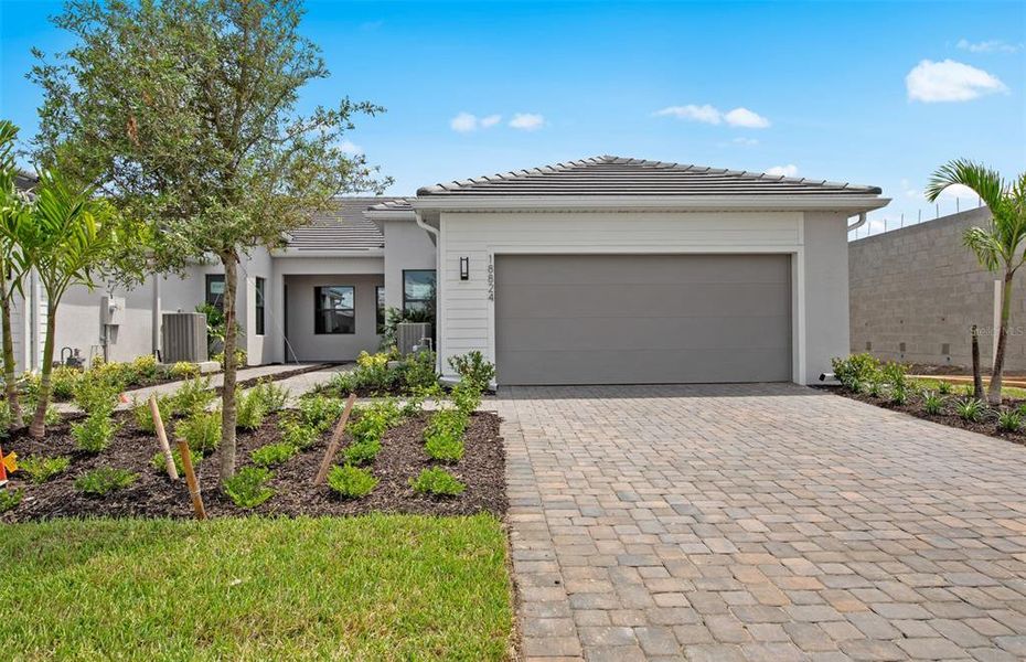 Front exterior of a new home in , Lakewood Ranch, FL, highlighting curb appeal (Image 1). Front exterior of a new home in , Lakewood Ranch, FL, highlighting curb appeal (Image 1).