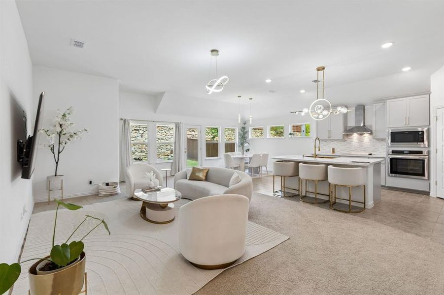Open-concept living space featuring light-toned walls and varied flooring
