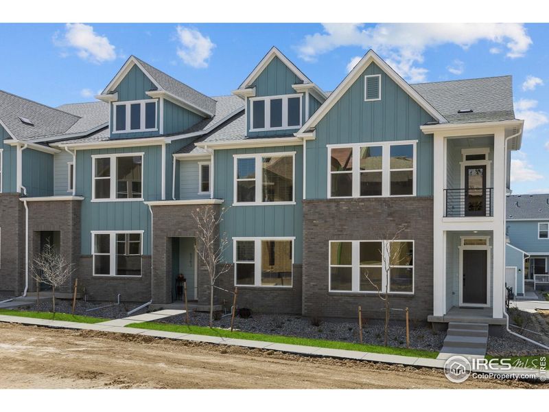 Front exterior of a new home in Kinston Mainstreet Townhomes, Loveland, CO, highlighting curb appeal (Image 22).
