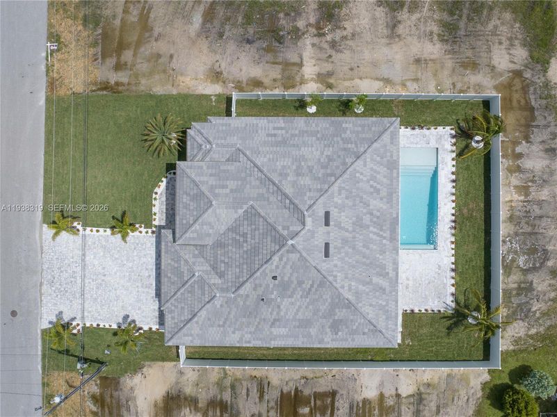 The home features a durable concrete tile roof, combining long-lasting protection with classic Southwest Florida style.