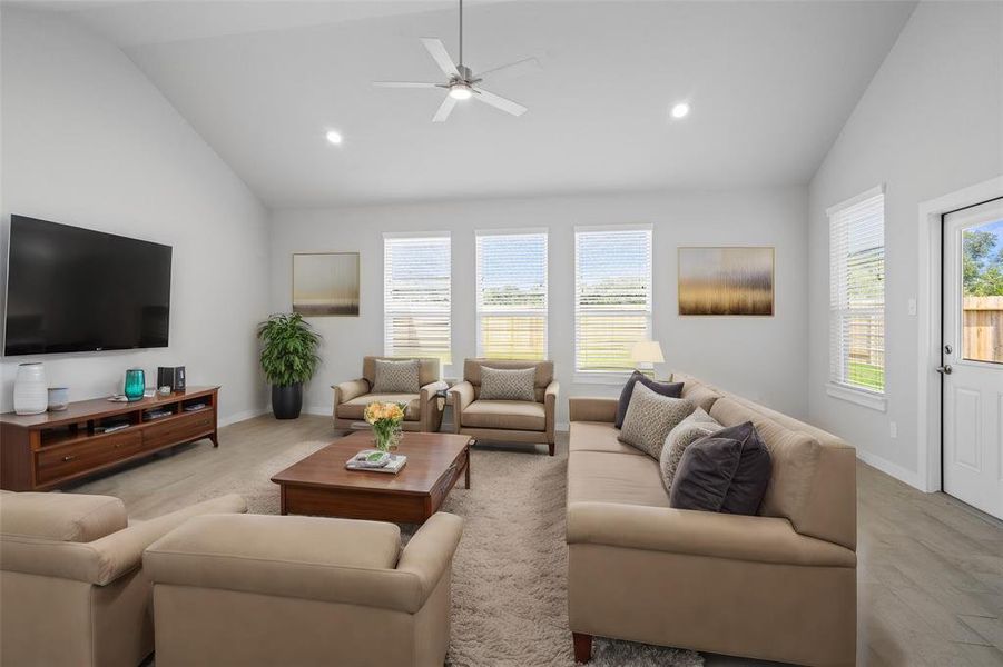 Gather the family and guests together in your lovely living room! Featuring high ceilings, recessed lighting, ceiling fan, custom paint, gorgeous floors and large windows that provide plenty of natural lighting throughout the day.