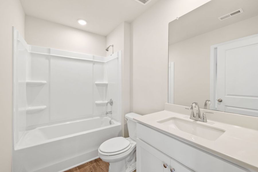 A bathroom with a tub sink and toilet. A bathroom with a tub sink and toilet.