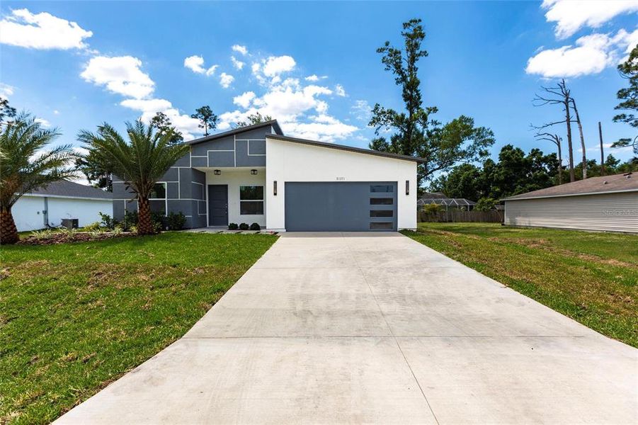 Front exterior of a new home in , Punta Gorda, FL, highlighting curb appeal (Image 1).