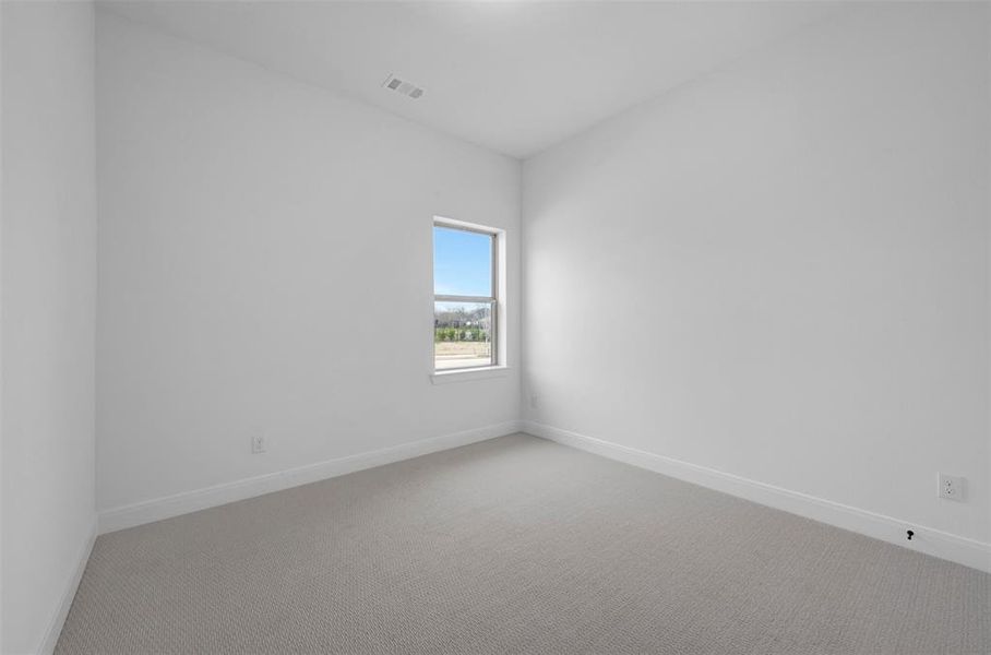 Empty room with carpet floors and baseboards