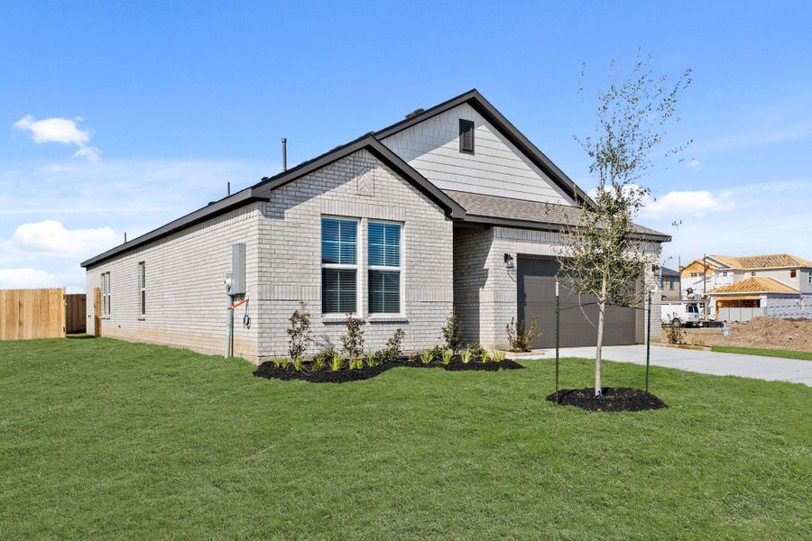 Front exterior of a new home in Pearlbrook, Texas City, TX, highlighting curb appeal (Image 2). Front exterior of a new home in Pearlbrook, Texas City, TX, highlighting curb appeal (Image 2).