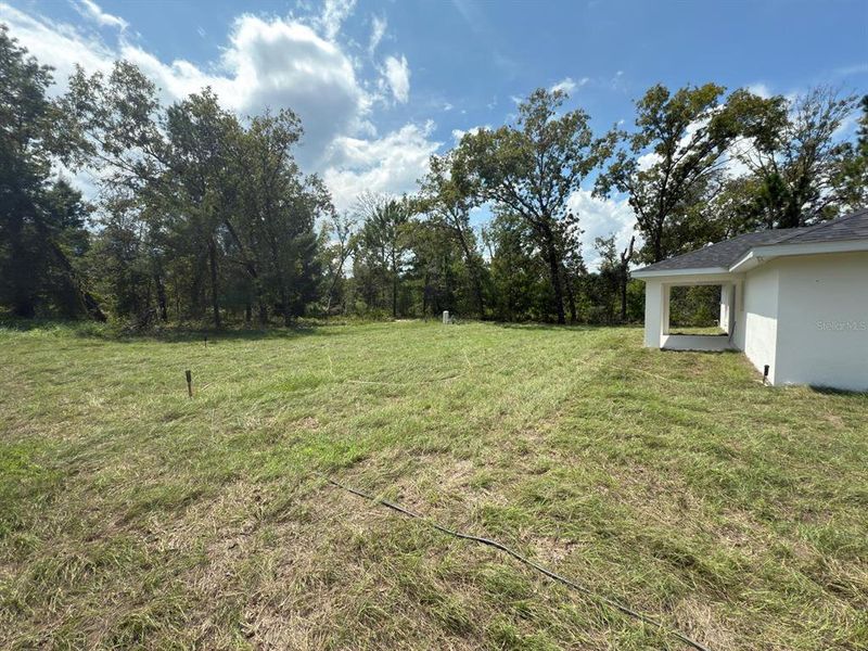 Front exterior of a new home in , Ocklawaha, FL, highlighting curb appeal (Image 1).