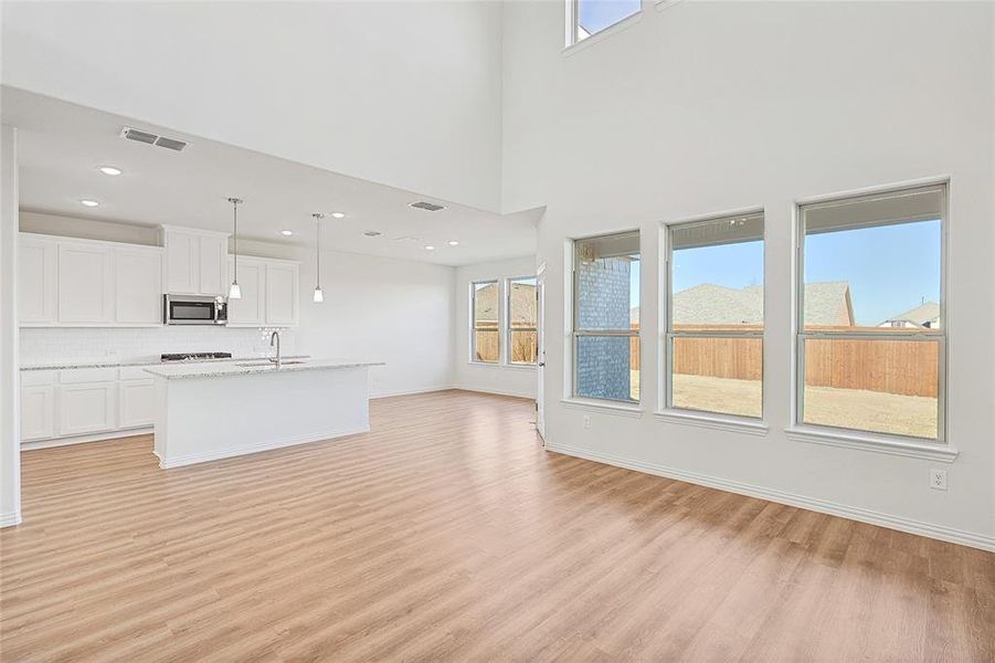 Unfurnished living room featuring light wood-style flooring and baseboards
