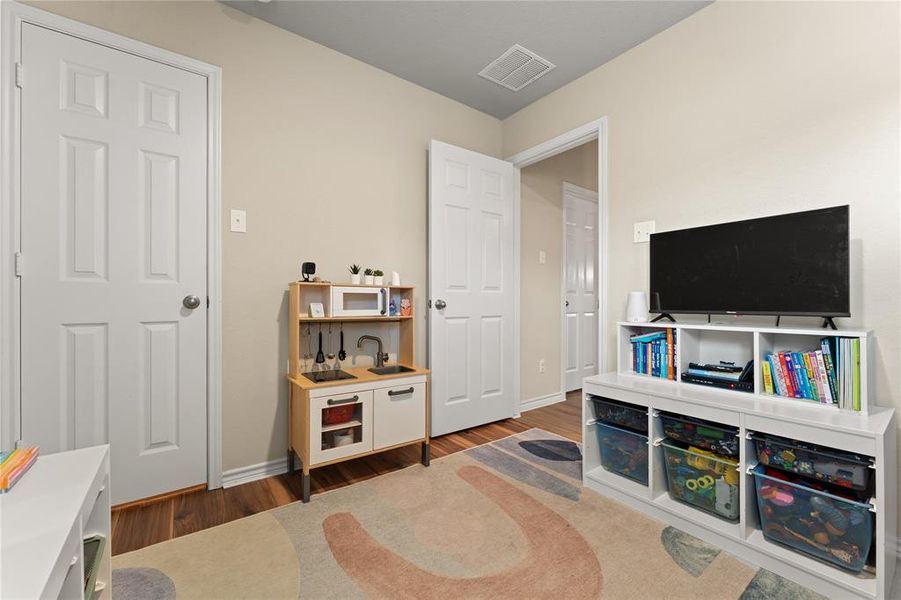 Living area with wood finished floors and baseboards