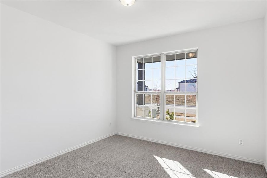 Bright room with white painted walls and gray carpet flooring