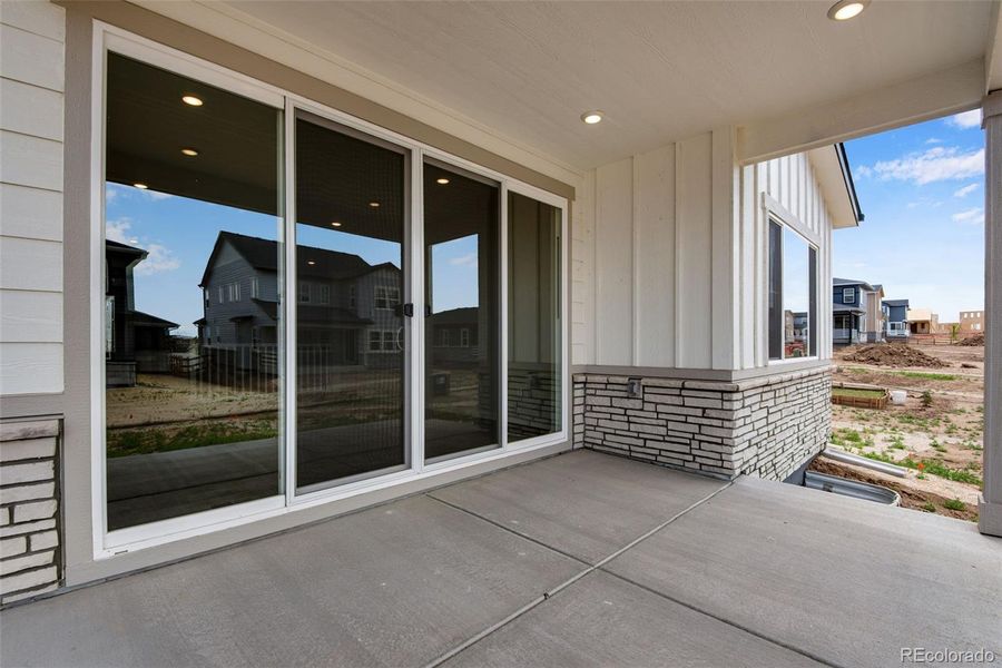 Exterior details and patio area of a home in Ensemble at The Aurora Highlands, Aurora (Image 21).