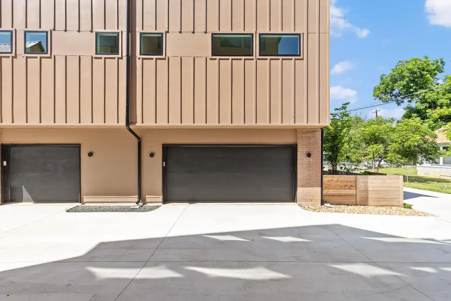 Clean lines and a spacious concrete driveway highlight this contemporary multi-level exterior design. Clean lines and a spacious concrete driveway highlight this contemporary multi-level exterior design.