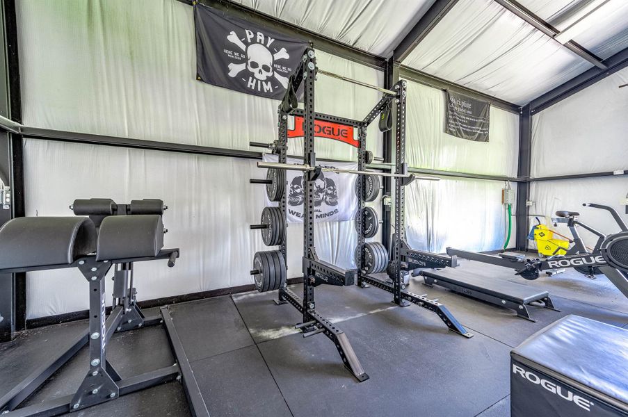 The interior setup includes a well-equipped fitness area with ample room for strength training, cardio equipment, and workout stations. The organized layout and open design make the space both functional and motivating for everyday use.