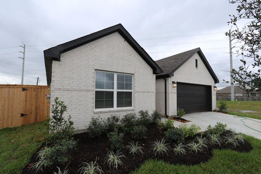 Front exterior of a new home in Ambrose, La Marque, TX, highlighting curb appeal (Image 18). Front exterior of a new home in Ambrose, La Marque, TX, highlighting curb appeal (Image 18).