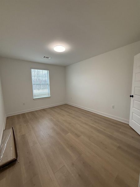 Empty room featuring light wood-style flooring and baseboards