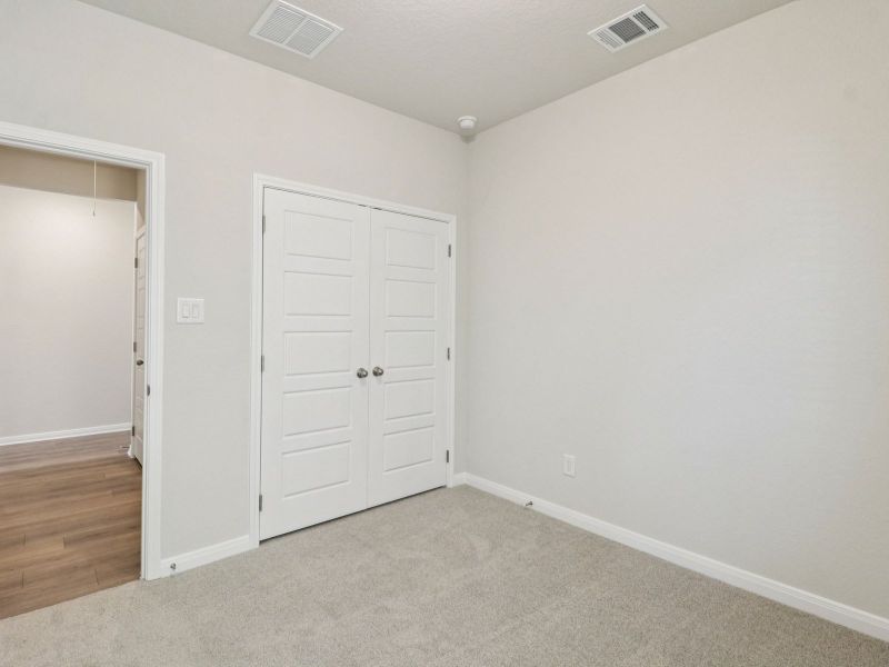 Guest bedroom in the Callaghan floorplan at a Meritage Homes community.