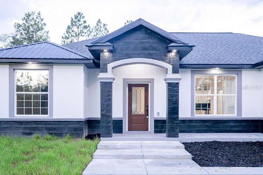 Front exterior of a new home in , Dunnellon, FL, highlighting curb appeal (Image 28). Front exterior of a new home in , Dunnellon, FL, highlighting curb appeal (Image 28).