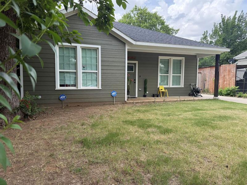 View of front of house featuring roof with shingles and covered porch