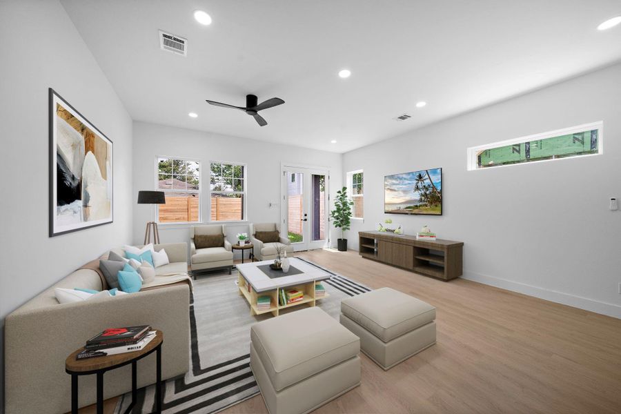Staged photo of living room. This is a spacious, modern living room with light LVP flooring and white walls. Staged photo of living room. This is a spacious, modern living room with light LVP flooring and white walls.