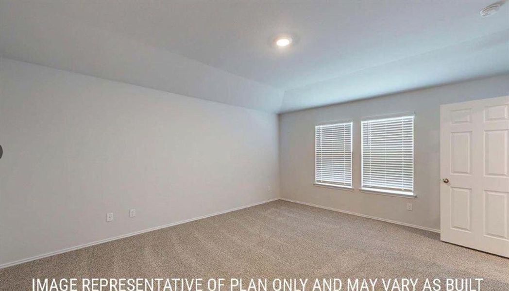 Spacious room featuring neutral carpeting, light-colored walls, and a tray ceiling with recessed lighting Spacious room featuring neutral carpeting, light-colored walls, and a tray ceiling with recessed lighting