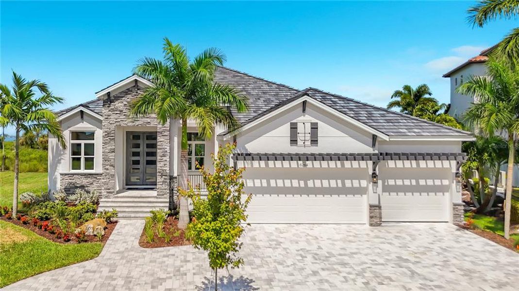 Front exterior of a new home in Legends Bay, Bradenton, FL, highlighting curb appeal (Image 1). Front exterior of a new home in Legends Bay, Bradenton, FL, highlighting curb appeal (Image 1).
