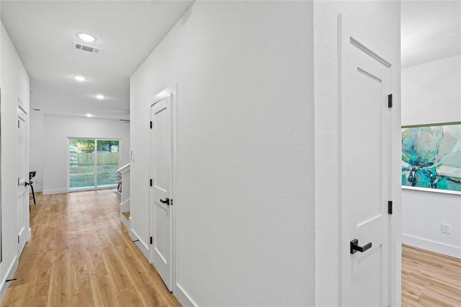 Corridor with light wood-type flooring