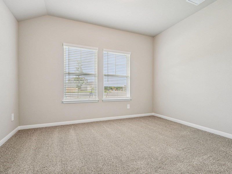 Unfurnished room featuring carpet flooring and lofted ceiling Unfurnished room featuring carpet flooring and lofted ceiling