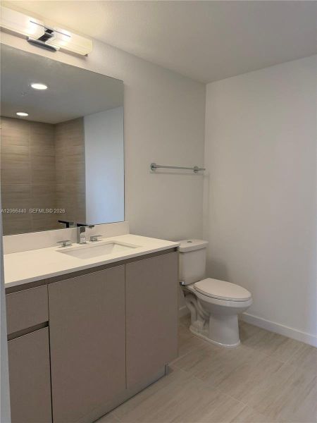 Spacious master bathroom with dual sinks and a neutral palette, perfect for adding your own style and decorations.
