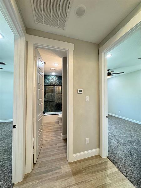 Hallway featuring wood-finish tile flooring and recessed lighting