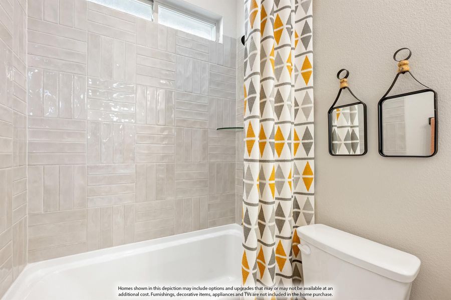 Bathroom with white subway tile tub surround, patterned shower curtain, and two small wall mirrors Bathroom with white subway tile tub surround, patterned shower curtain, and two small wall mirrors