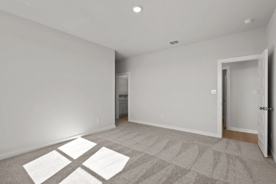 A room with white walls and a rug.