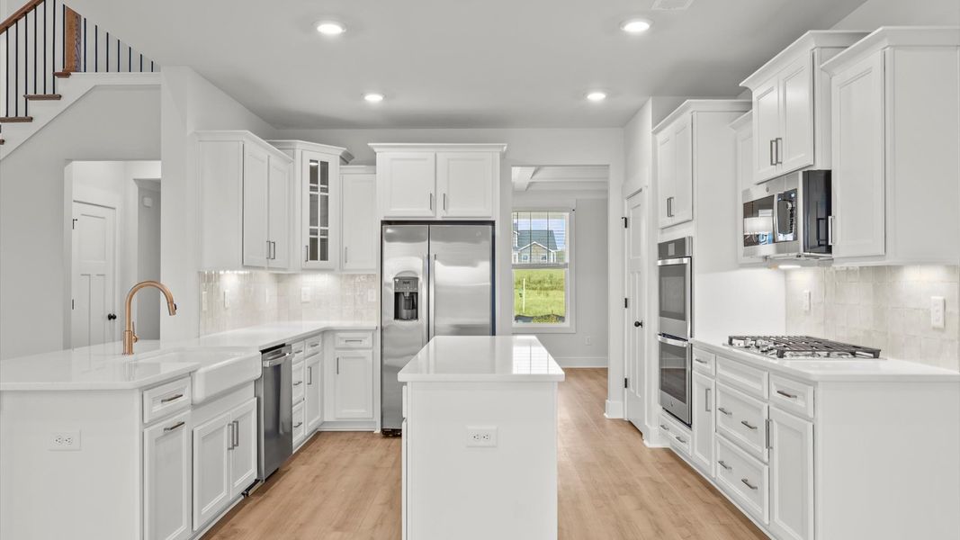 Well-designed kitchen with a center island and tasteful finishes that elevate everyday living Well-designed kitchen with a center island and tasteful finishes that elevate everyday living