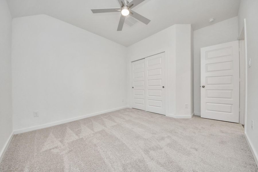 Generously sized secondary bedrooms featuring spacious closets, soft and inviting carpeting underfoot, large windows allowing plenty of natural light, and the added touch of privacy blinds for your personal retreat.