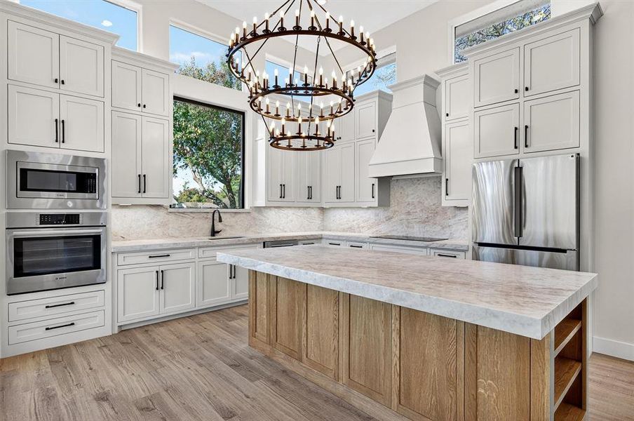 Kitchen featuring open shelves, stainless steel appliances, custom exhaust hood, a high ceiling, and white cabinets