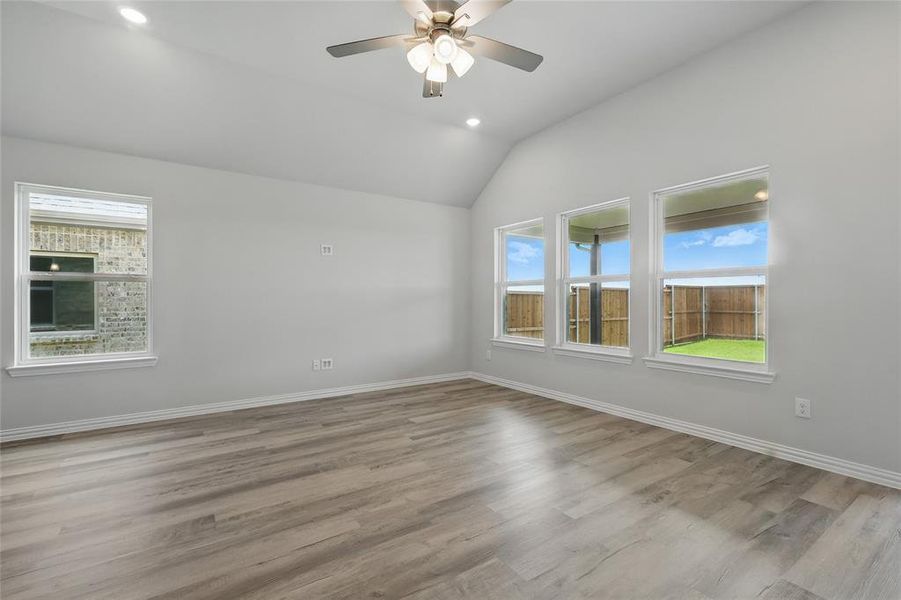 Unfurnished room featuring a ceiling fan, wood finished floors, lofted ceiling, and recessed lighting Unfurnished room featuring a ceiling fan, wood finished floors, lofted ceiling, and recessed lighting