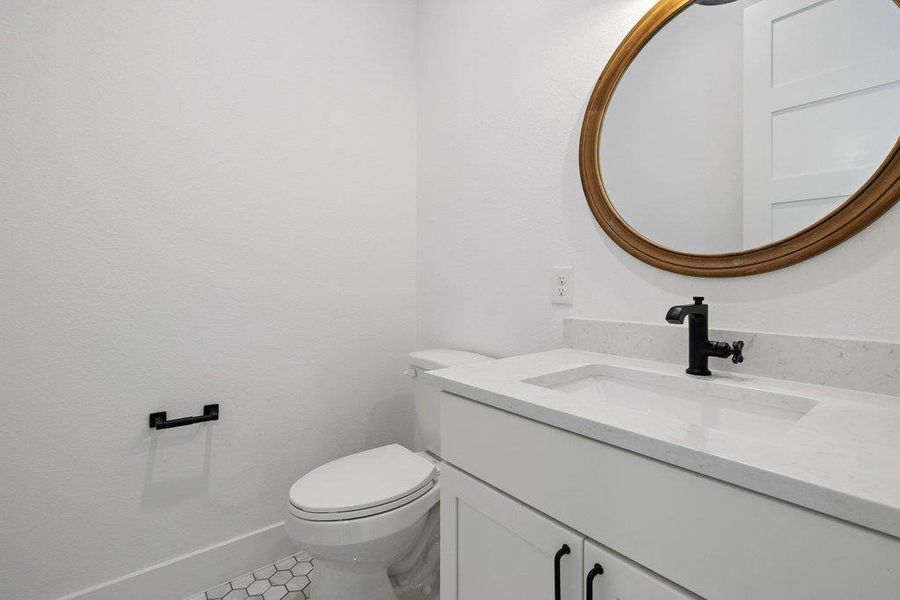 Bathroom featuring vanity and toilet