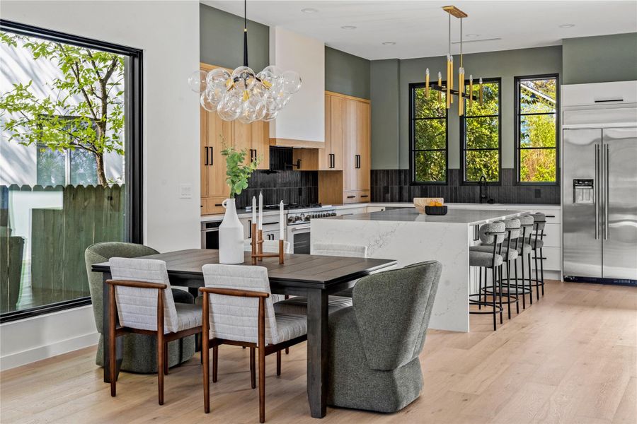 Dining space with a chandelier, light wood-style flooring, and recessed lighting