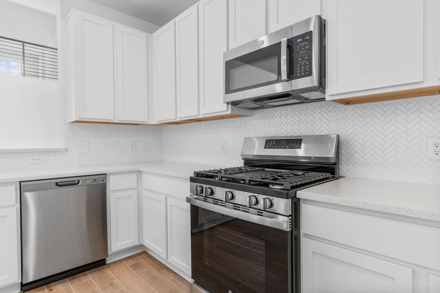 Additional kitchen view showcasing the sleek stainless steel gas range, built-in microwave, and abundant cabinetry — a perfect blend of style and function. Additional kitchen view showcasing the sleek stainless steel gas range, built-in microwave, and abundant cabinetry — a perfect blend of style and function.