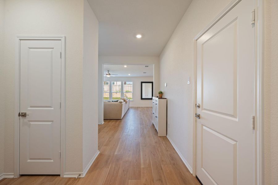 Hall featuring light wood-style floors and recessed lighting Hall featuring light wood-style floors and recessed lighting