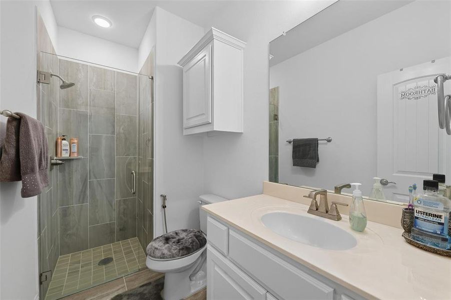 Full bath featuring vanity and a shower stall Full bath featuring vanity and a shower stall