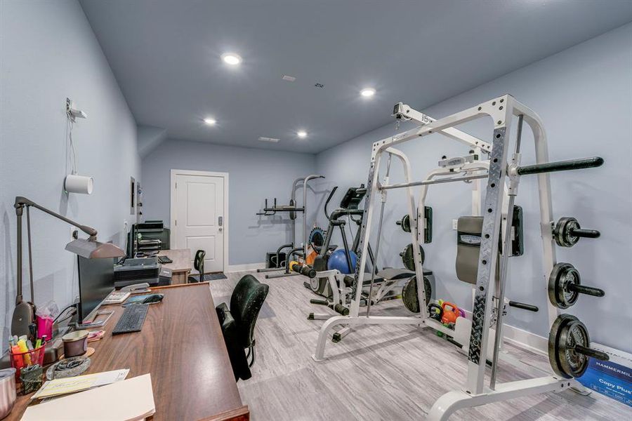 Exercise room with hardwood / wood-style flooring