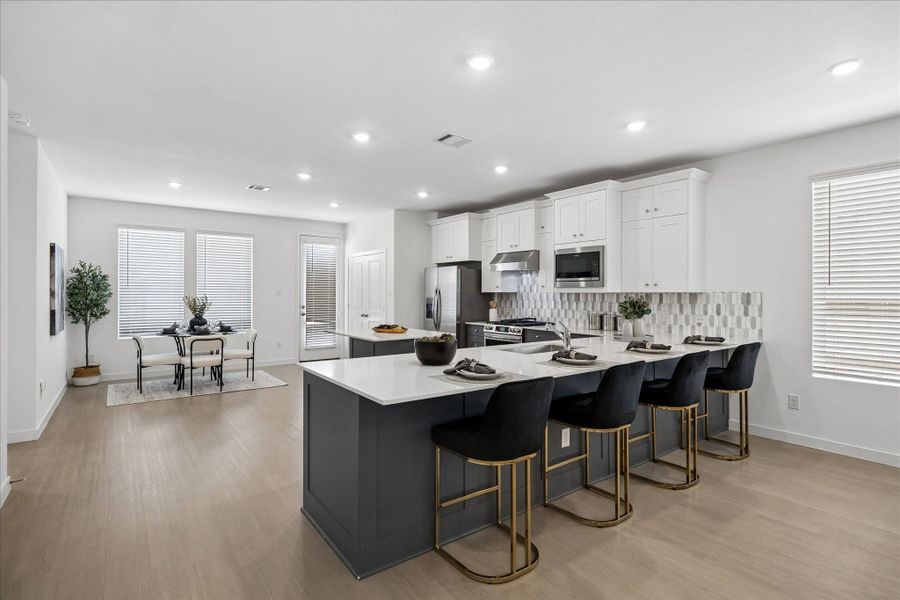 Casual living comes naturally in this eat in kitchen, where bar seating and a sunny dining nook give you options for every meal, while a pantry, utility closet and easy back patio access keep daily routines running smoothly.