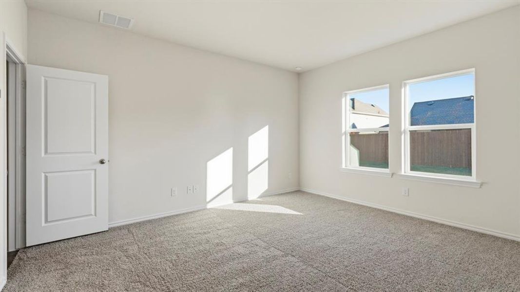 Spare room with light carpet and baseboards